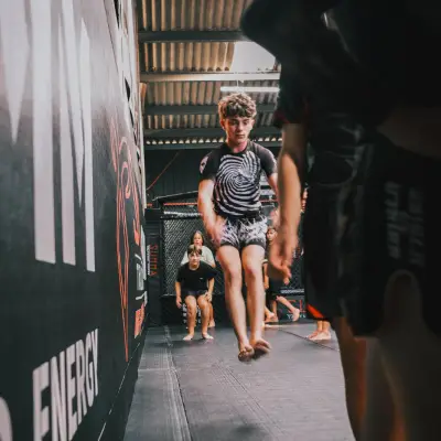 Enfant en plein saut pendant le cours MMA kids au Summa